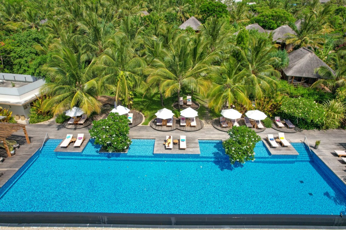 Beautiful Zanzibar beach and beachfront hotel surrounded by tropical scenery and clear turquoise waters.