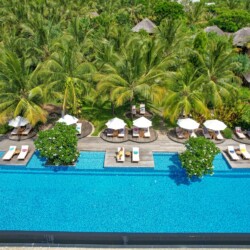 Beautiful Zanzibar beach and beachfront hotel surrounded by tropical scenery and clear turquoise waters.